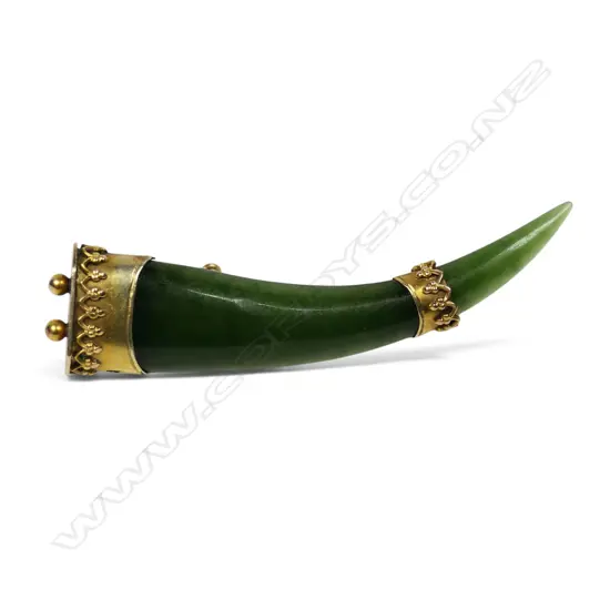 A late 19thC gilded 9ct gold and pounamu tusk form brooch,