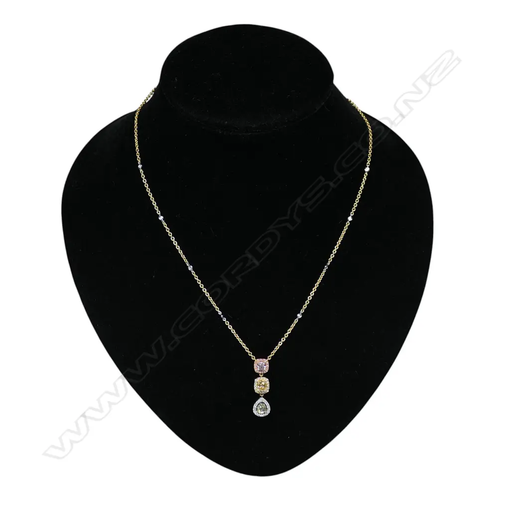 An 18ct white rose and yellow gold graduated shaped diamond drop necklace, Image 1++