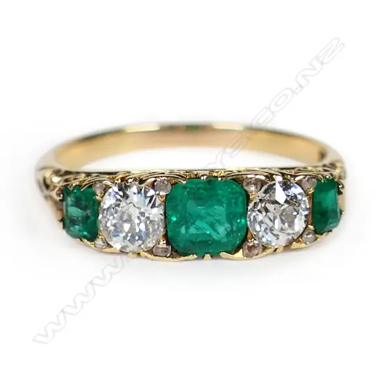 An estate 18ct gold emerald and diamond ring,