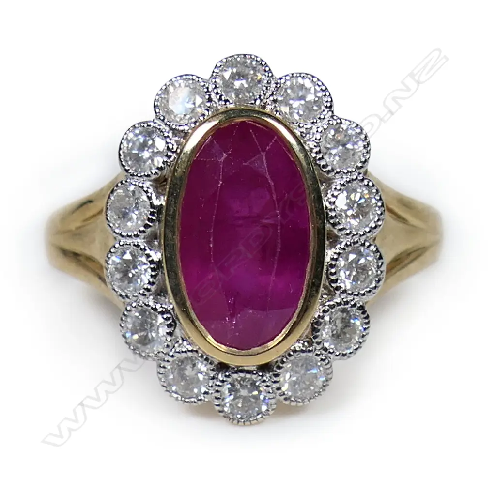 A 14ct gold ruby and diamond halo ring, Image 1++