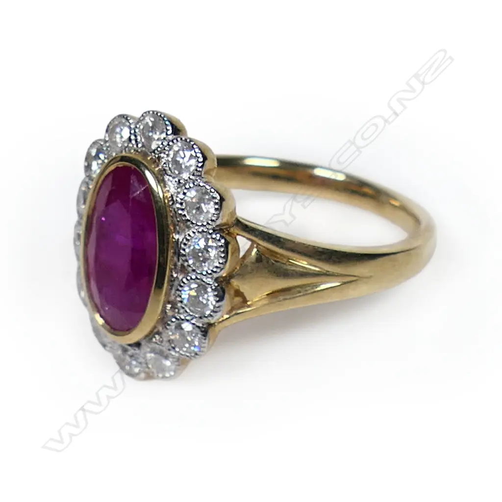A 14ct gold ruby and diamond halo ring, Image 1++