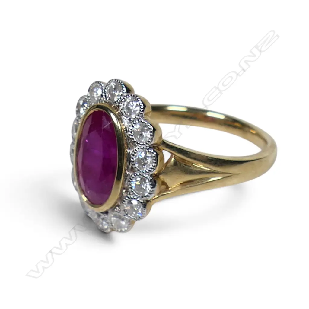 A 14ct gold ruby and diamond halo ring, Image 1++