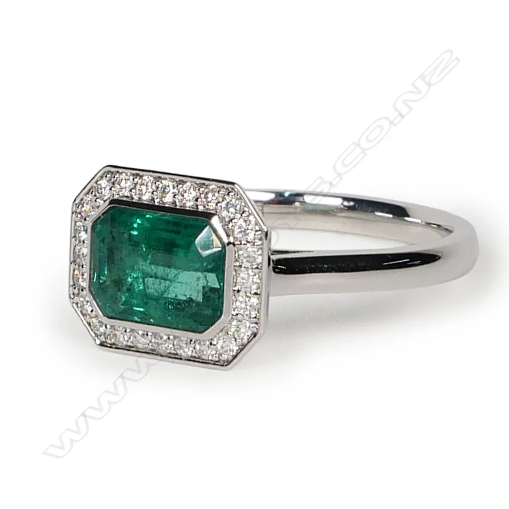 An 18ct white gold emerald and diamond ring, Image 1++