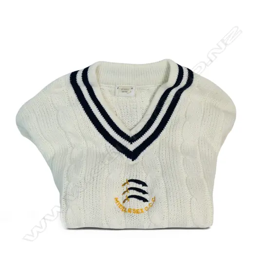 An unused MCC player jersey - identified as a 'player ' garment by the emblem directly centred below the V neck,