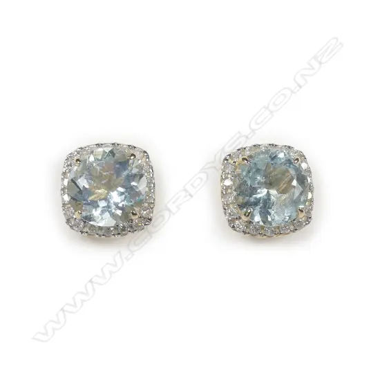 A pair of 14ct yellow gold aquamarine and diamond halo stud earrings