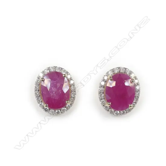 A pair of 14ct yellow and white gold ruby and diamond halo earrings