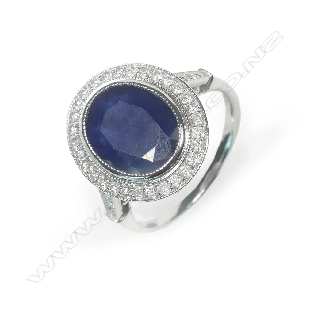 A 14ct white gold sapphire and diamond halo ring Image 1++