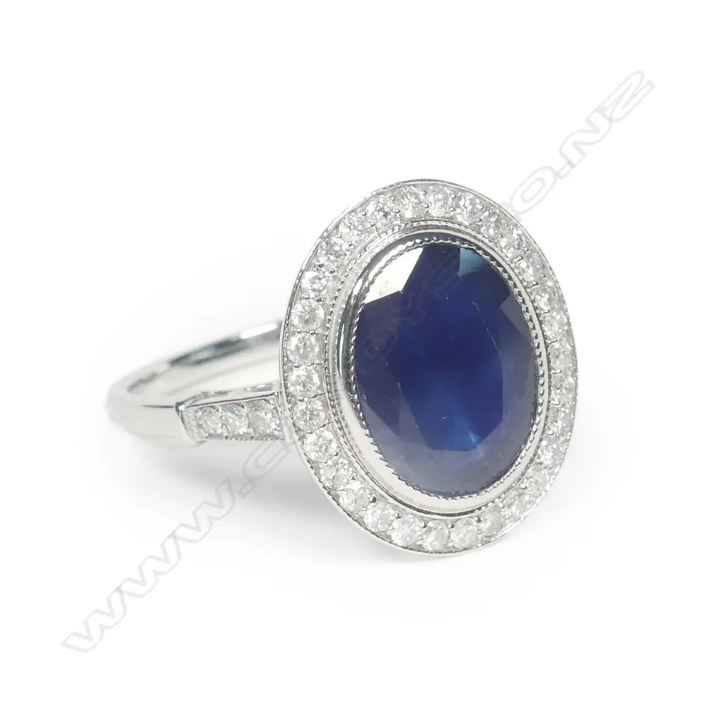 A 14ct white gold sapphire and diamond halo ring Image 1++