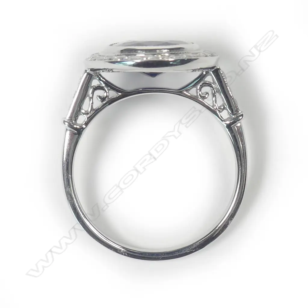 A 14ct white gold sapphire and diamond halo ring Image 1++