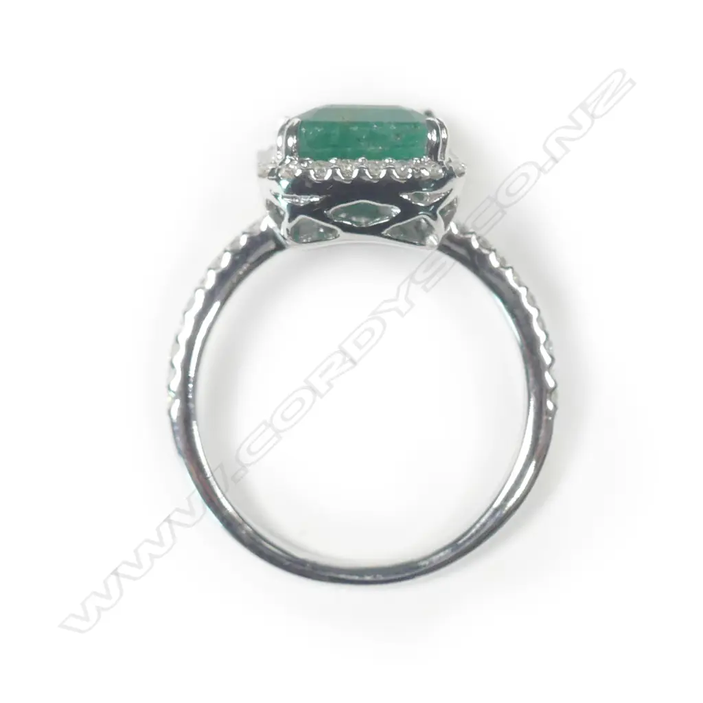 A 14ct white gold emerald and diamond halo ring Image 1++