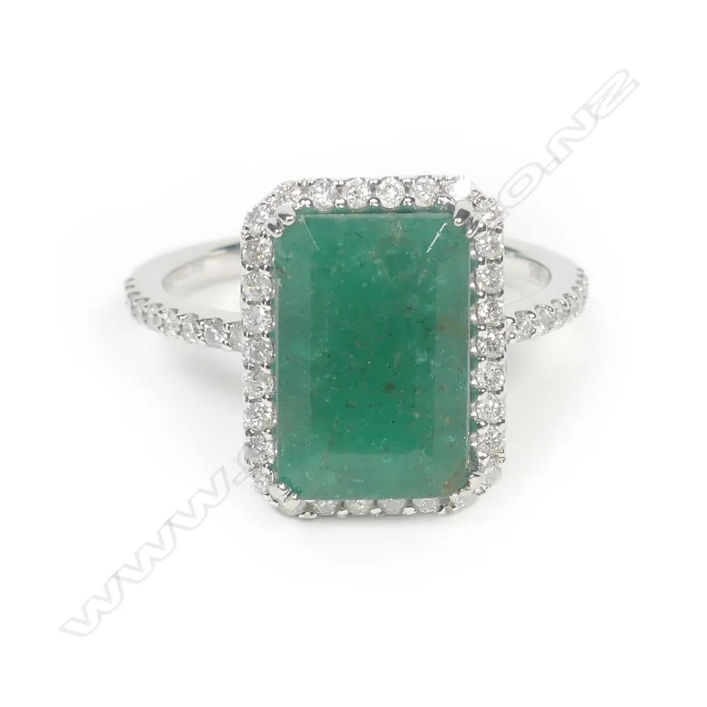 A 14ct white gold emerald and diamond halo ring Image 1++