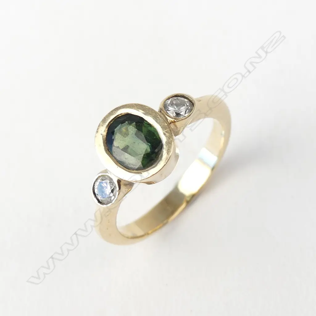A 9ct gold green sapphire and diamond ring Image 1++