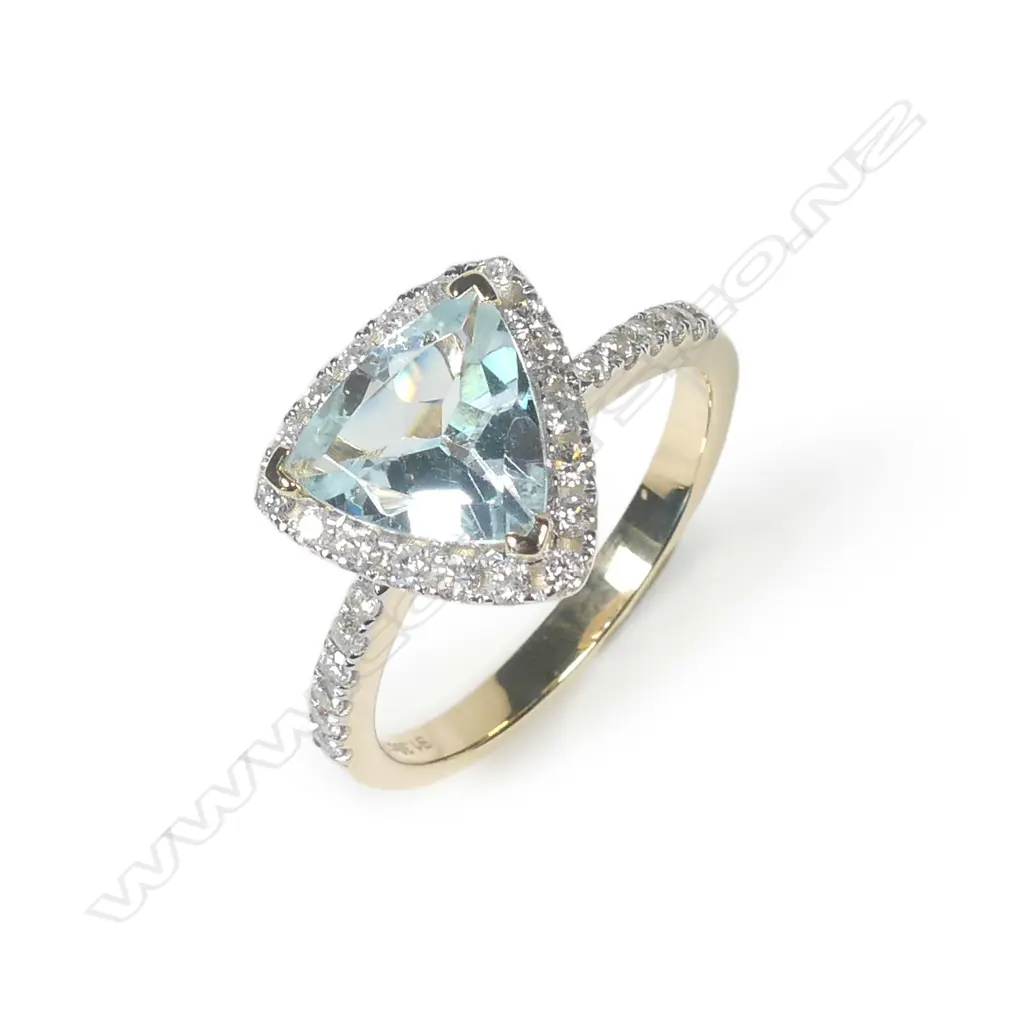 A 14ct yellow gold aquamarine and diamond halo ring Image 1++