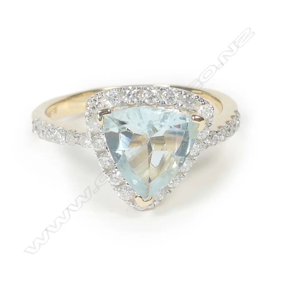 A 14ct yellow gold aquamarine and diamond halo ring Image 1++