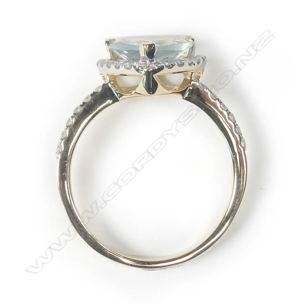 A 14ct yellow gold aquamarine and diamond halo ring Image 1++