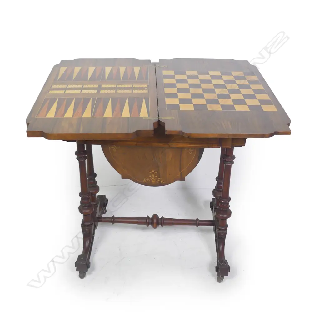 A Victorian walnut games table Image 1++