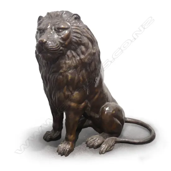 A large classical style seated bronze lion sejant