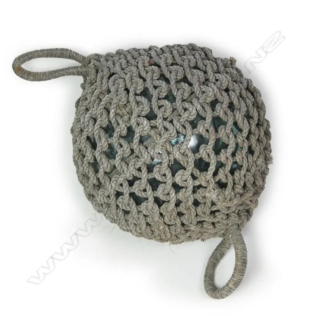A large old glass fishing float with netting Image 1++