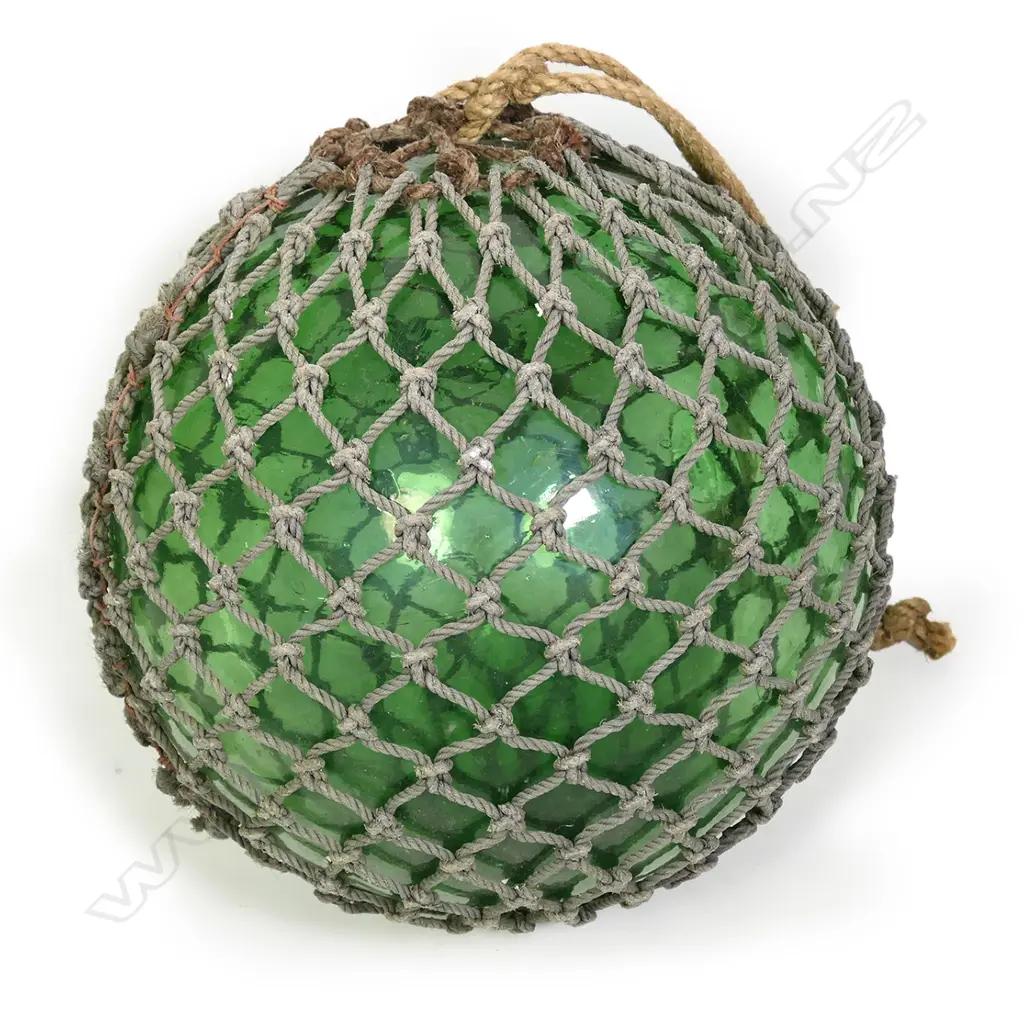 A large old glass fishing float with netting Image 1++