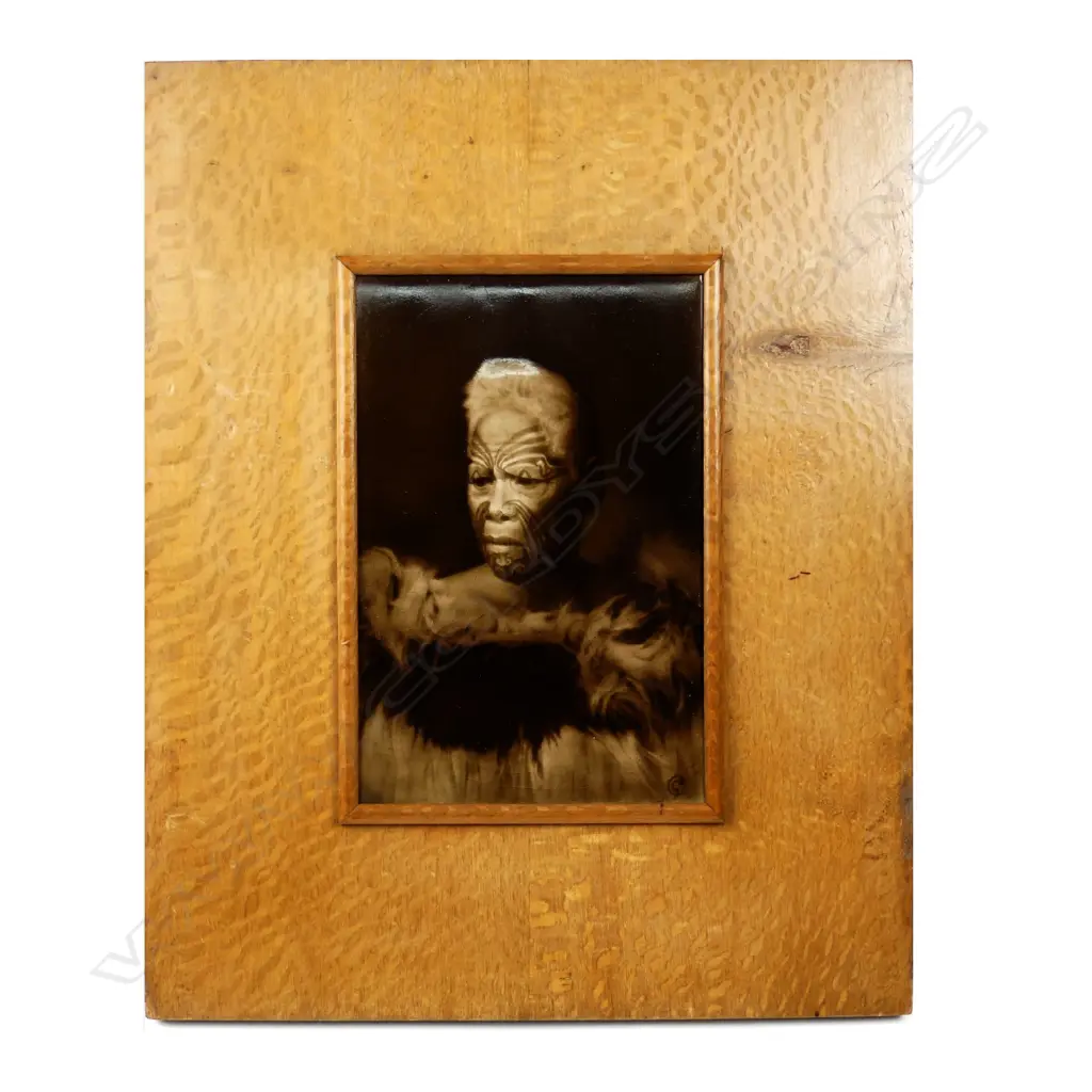 A c.1900 Sherwin & Cotton Māori portrait tile of the chief 'Matene Te Nga', depicted with full moko and in a korowai (cloak), the chief of Ngati Maru iwi, entitled top left, the artist George Cartlidge’s monogram bottom right, maker's marks to reverse. 225 x 150mm.Professional restoration, in old rewarewa frame, the reverse with outline and starting of Māori carved detail. Image 1++
