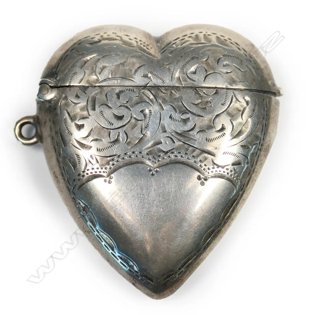 A late Victorian silver heart form engraved vesta Image 1++