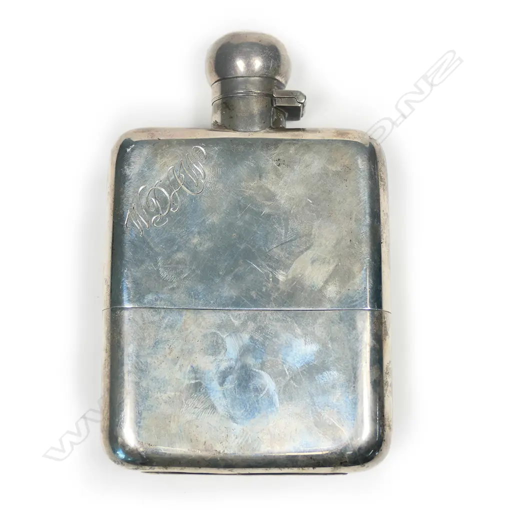 A silver hip flask Image 1++