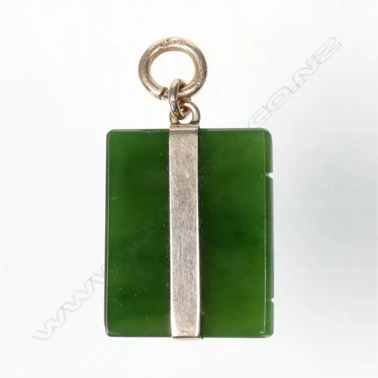 An early 20thC greenstone and 9ct. gold mounted book form pendant