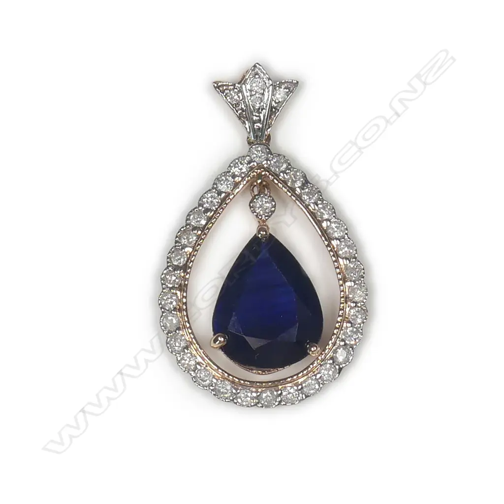 A 14ct rose gold sapphire and diamond drop style halo pendant Image 1++