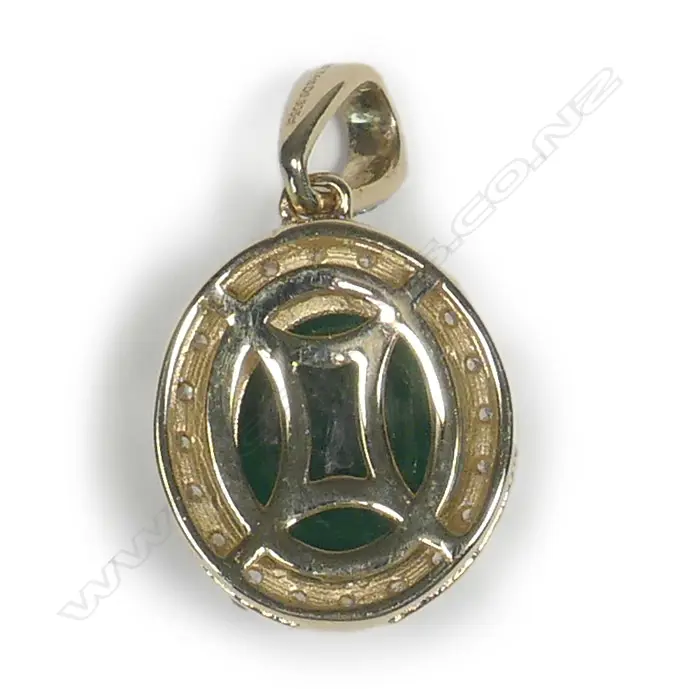 A 14ct gold emerald and diamond halo pendant Image 1++