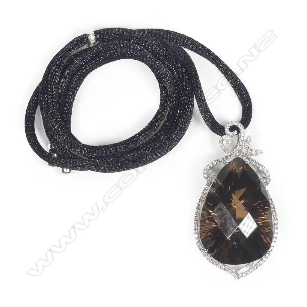 An 18ct white gold diamond and amethyst pendant Image 1++