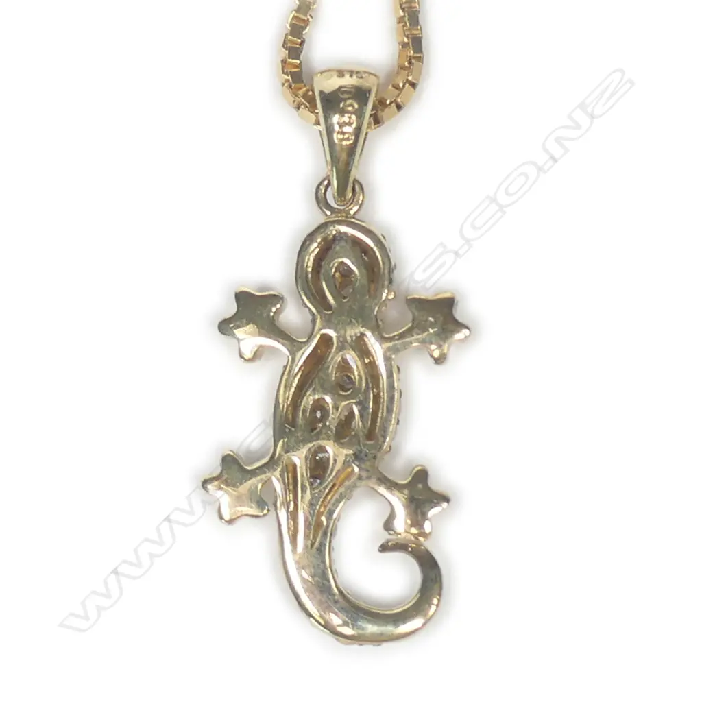 A 9ct gold diamond pendant and chain Image 1++