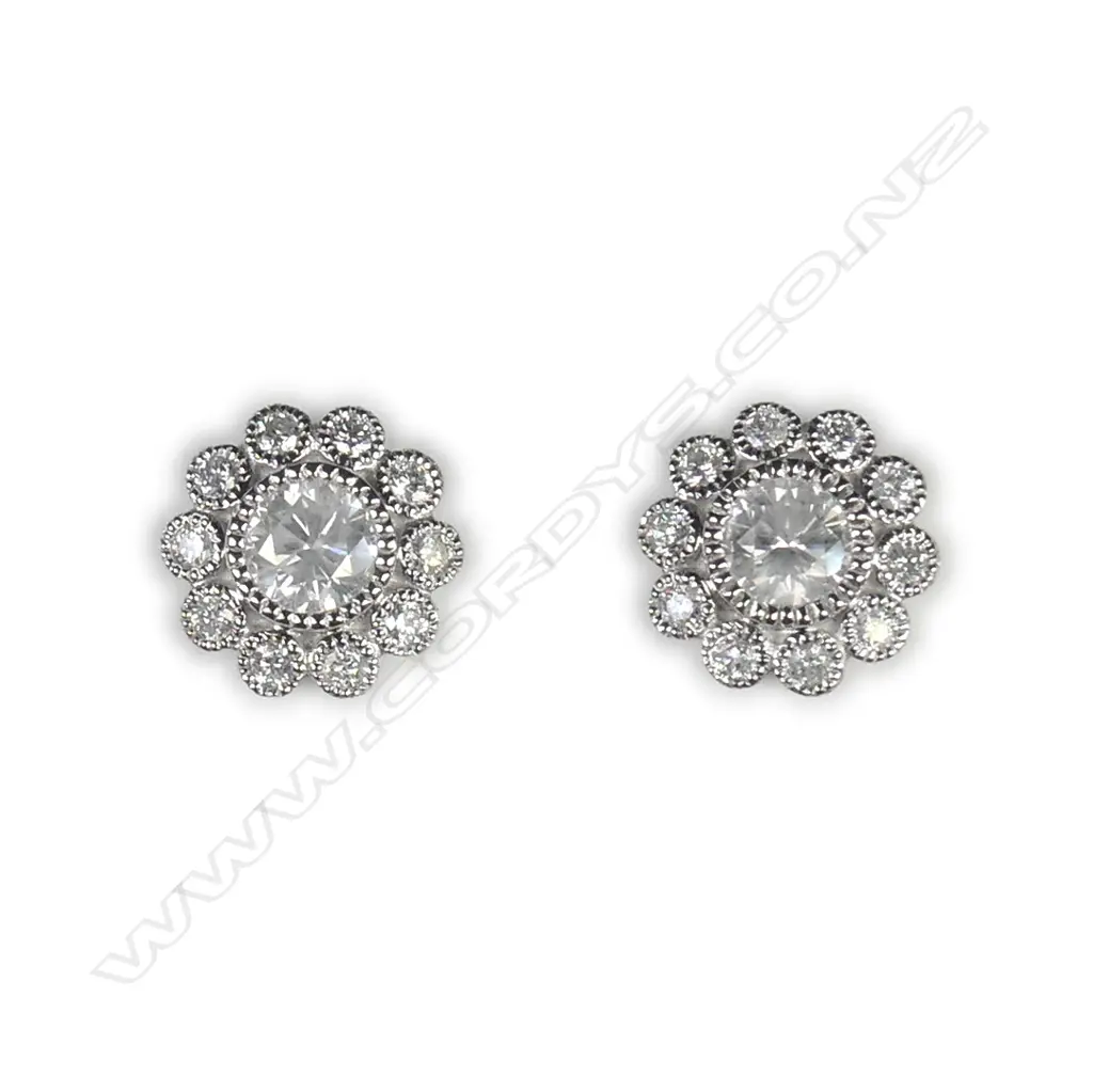 A pair of 14ct white gold and diamond flower stud earrings Image 1++
