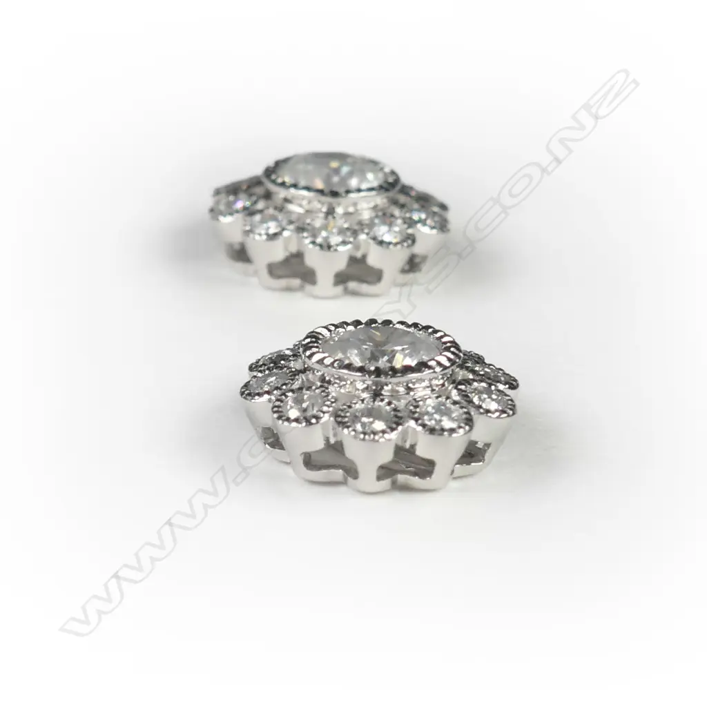 A pair of 14ct white gold and diamond flower stud earrings Image 1++