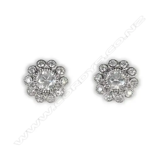A pair of 14ct white gold and diamond flower stud earrings