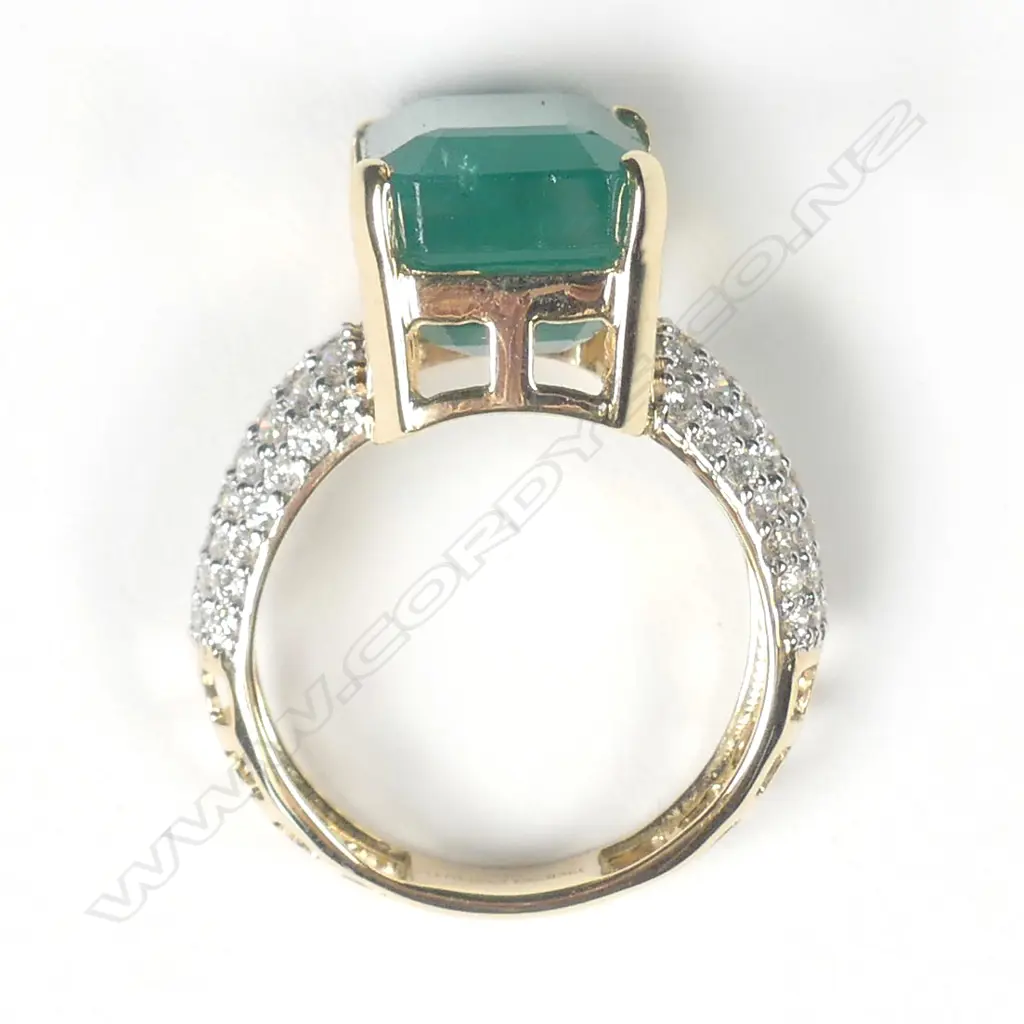 A 14ct yellow gold emerald and diamond dress ring Image 1++
