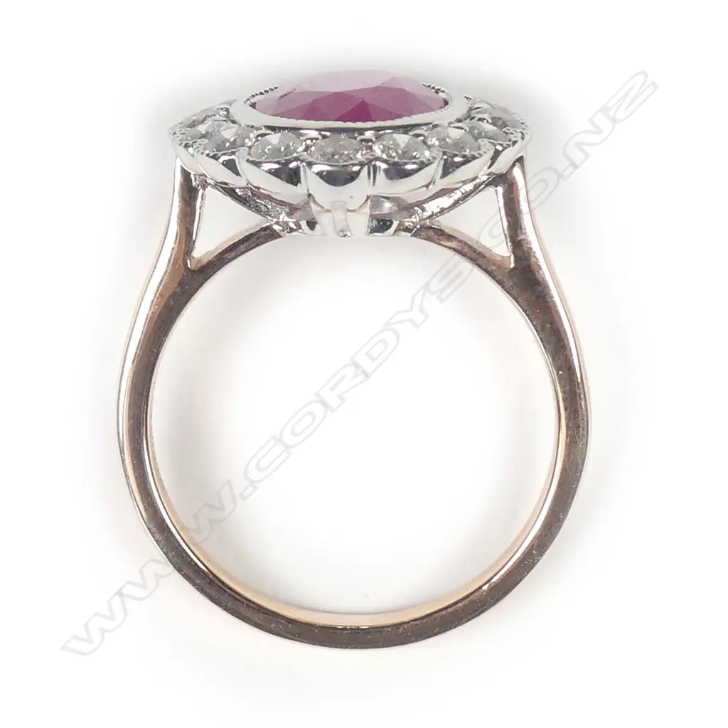 A 14ct rose gold ruby and diamond halo ring Image 1++