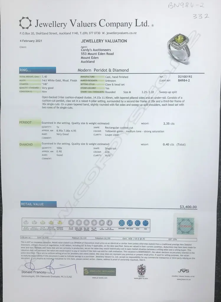 A 14ct white gold peridot and diamond halo ring Image 1++