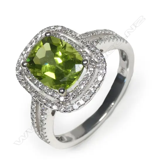 A 14ct white gold peridot and diamond halo ring
