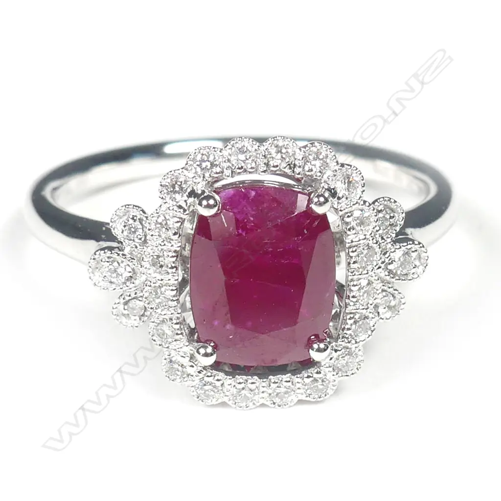 A 14ct white gold ruby and diamond halo ring Image 1++