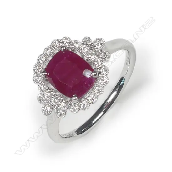 A 14ct white gold ruby and diamond halo ring