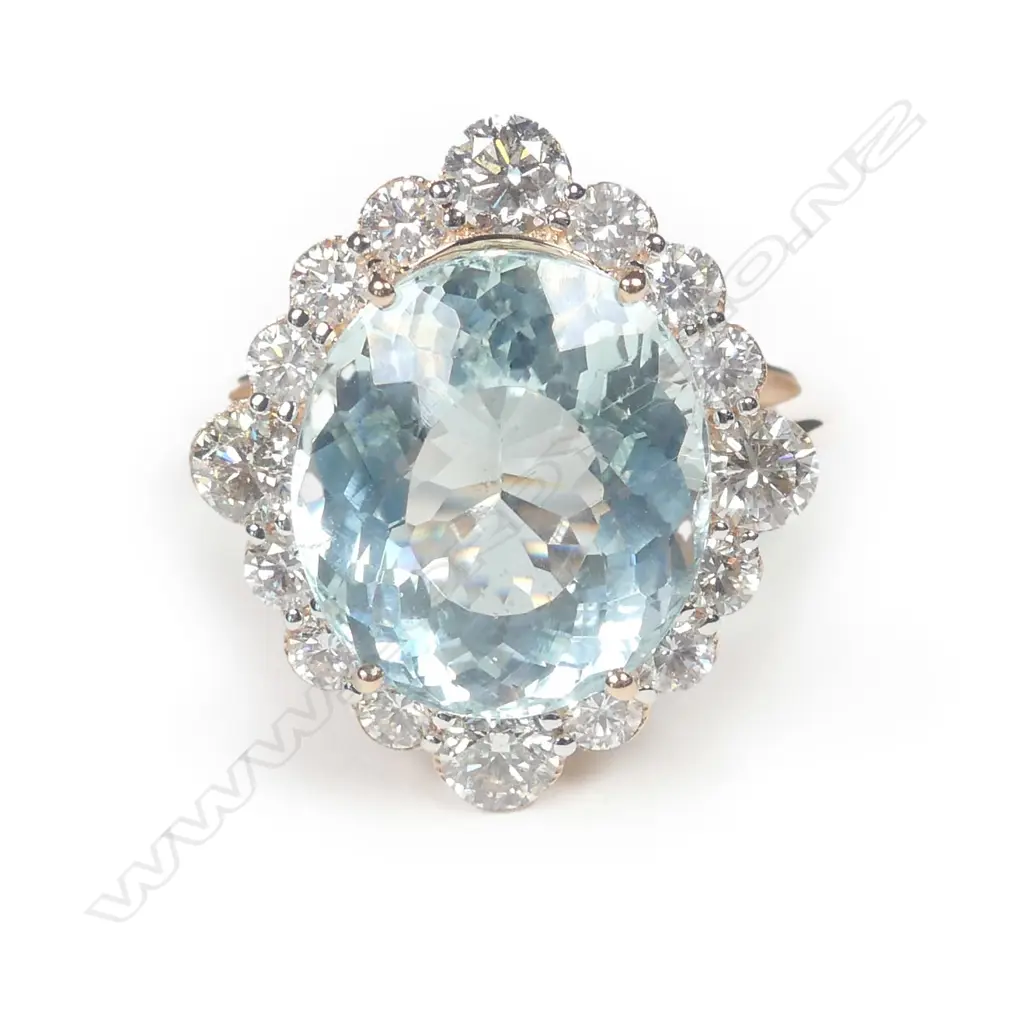 A 14ct rose gold aquamarine and diamond halo ring Image 1++