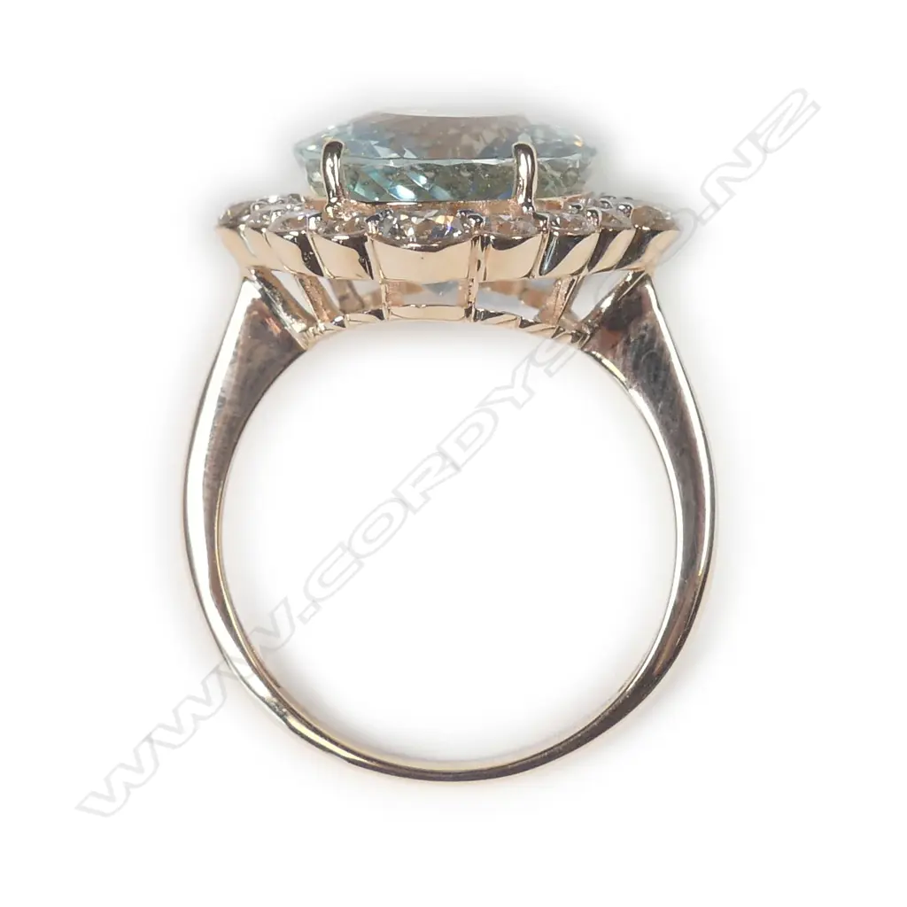 A 14ct rose gold aquamarine and diamond halo ring Image 1++