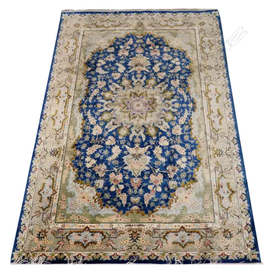 A silk hand-knotted rug
