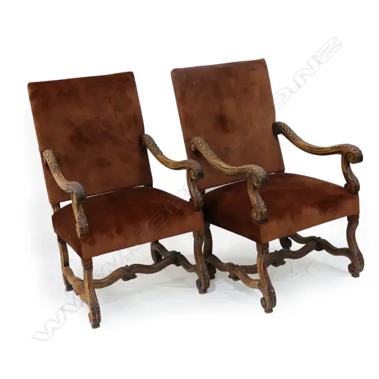 A pair of Baronial open elbow armchairs