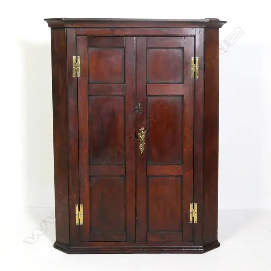A Georgian oak corner cupboard