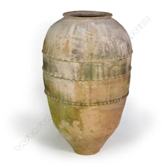 An old European terracotta tall olive oil storage jar