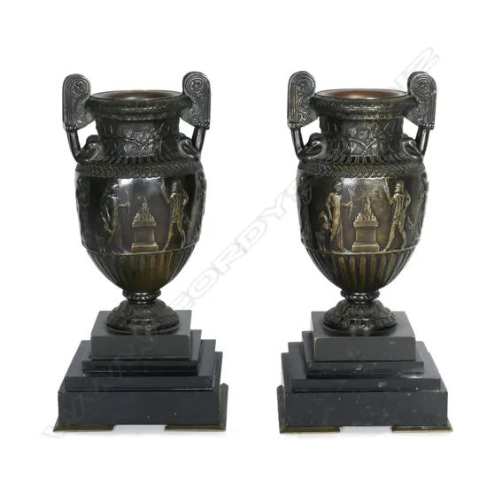 A pair of 19thC Roman style bronze urns on marble bases
