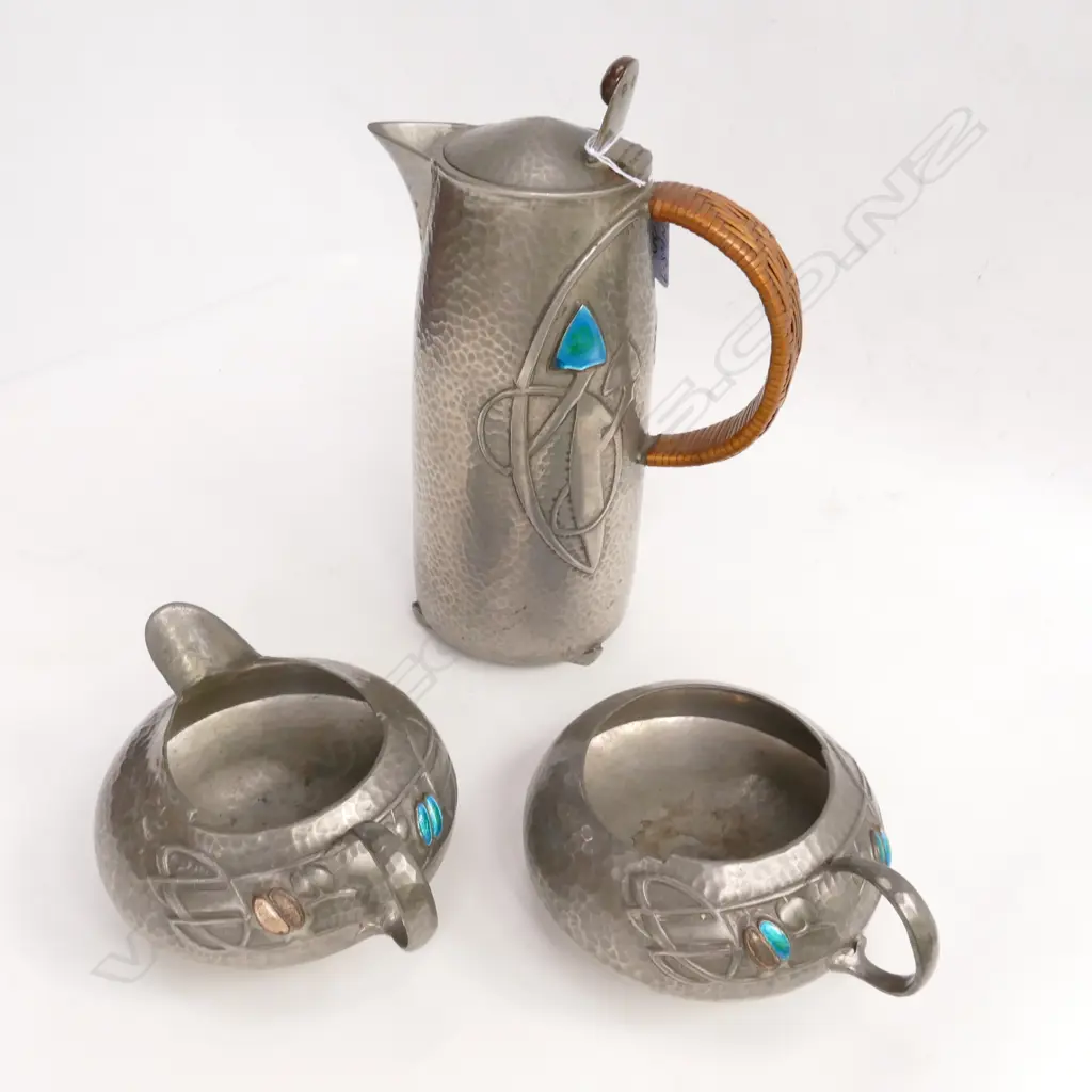 An Archibald Knox three-piece Tudric pewter part tea service Image 1++