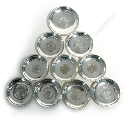 Ten small dishes set with coins to the centre