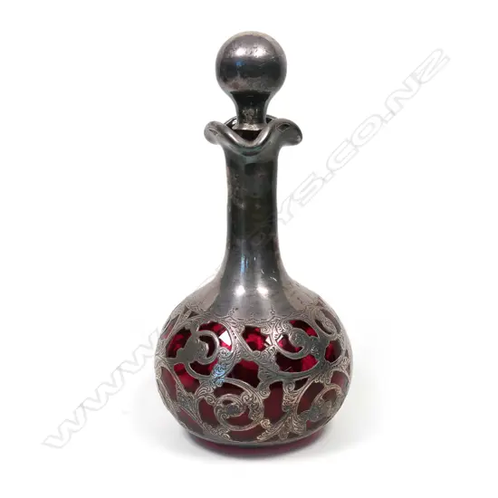 A late Victorian silver over ruby glass scent bottle